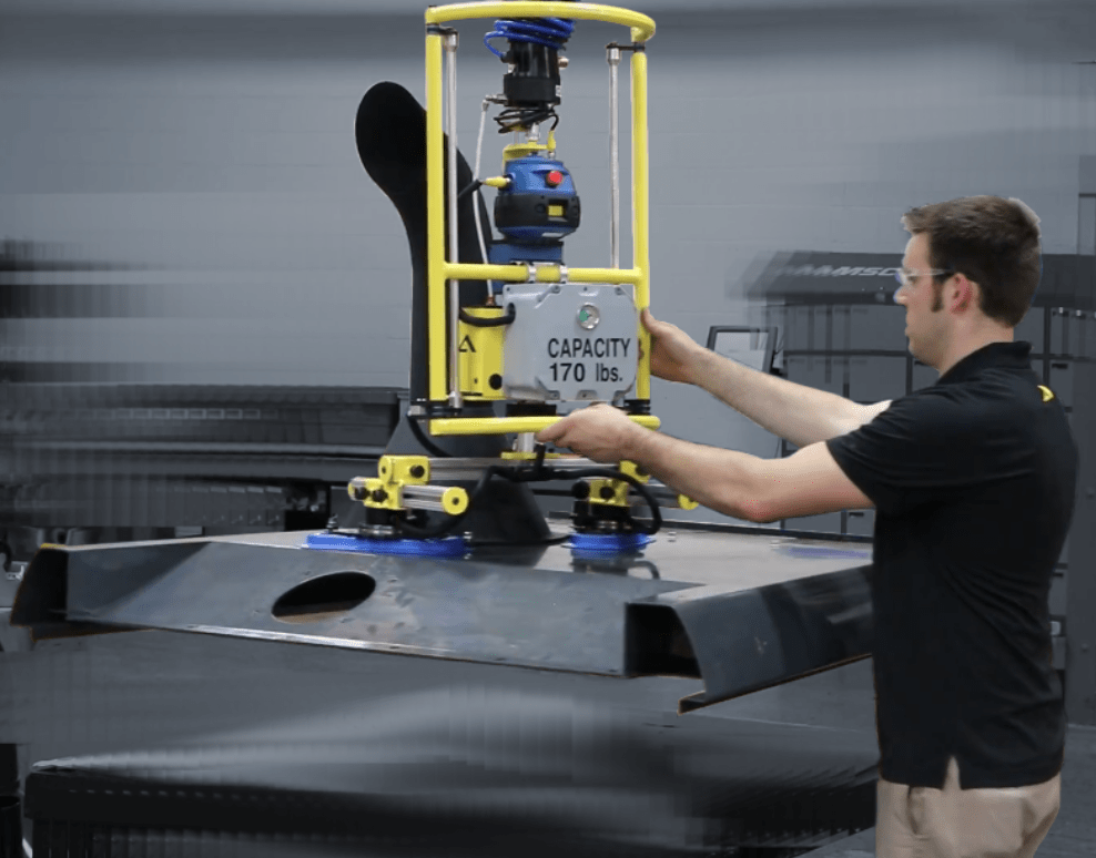 A worker operates a lifting device with a 170 lbs capacity to move material in an industrial setting, showcasing safety and efficiency in handling.